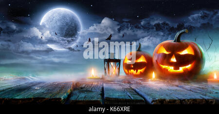 Jack O’ Lanterns Glowing At Moonlight In The Spooky Night - Halloween Scene Stock Photo