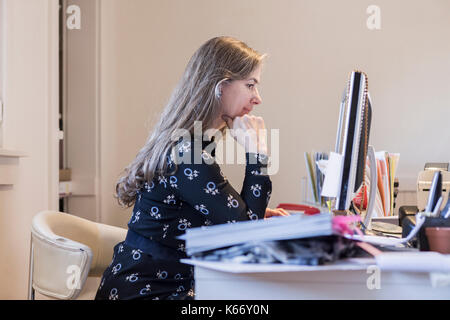 Older Caucasian businesswoman using a computer Stock Photo