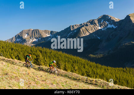 Caucasian couple mountain biking Stock Photo