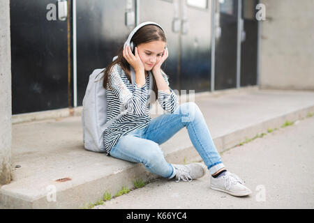 Elementary school pupil outside carrying rucksack Stock Photo