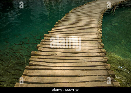 Wooden footbridge over water Stock Photo
