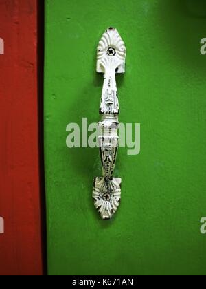 Photo of a white door handle on a green door Stock Photo