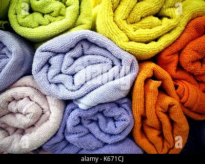 Photo of a stack of rolls of colorful bath towels Stock Photo