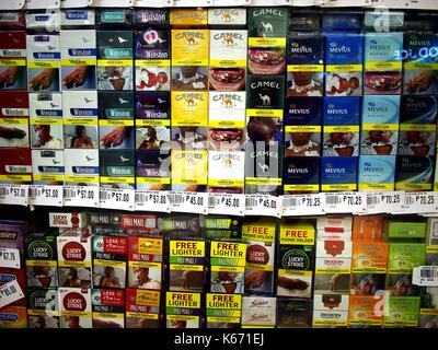 ANTIPOLO CITY, PHILIPPINES - SEPTEMBER 10, 2017: Assorted packs of cigarette  with warning labels on display at a grocery store Stock Photo