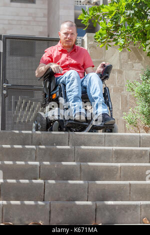 Wheelchair man in front of staircase Barrier Stock Photo