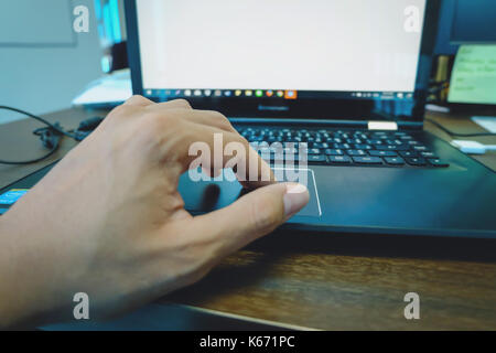 Left hand touchpad laptop, In the office Stock Photo