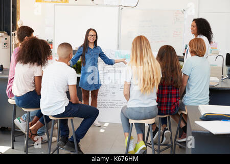Schoolgirl presenting in front of science class, close up Stock Photo