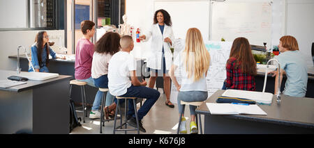 Science teacher giving presentation in school science class Stock Photo