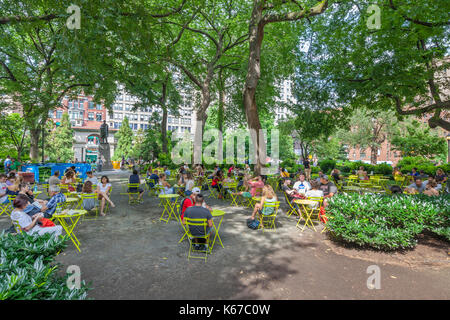 People enjoying leisure time in Union Square, New York near the Abraham Lincoln Monument. Stock Photo