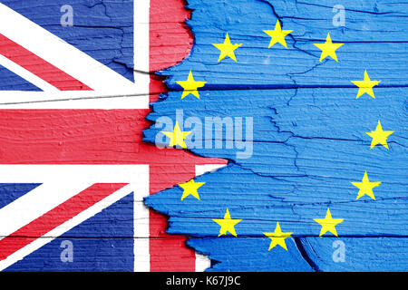 Brexit concept image: flags of the European Union (EU) and United Kingdom (UK) painted on a cracked broken wooden wall. Stock Photo