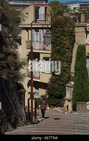 Walking up the cobbled steps of Le Suquet Old Town, Cannes, France Stock Photo