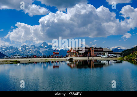 Landscape with the alpine hut and a lake on top of Nufenen Pass Stock Photo