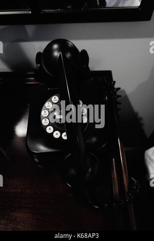 A vintage telephone with the reciever sitting off the base. Stock Photo