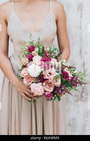 Сhic wedding bouquet of peonies and roses in hands of the bride Stock Photo