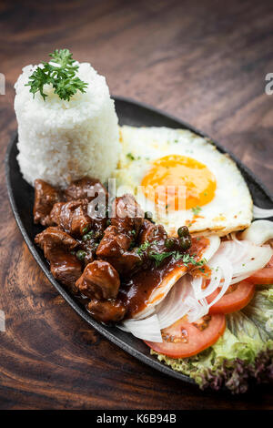 cambodian traditional khmer beef lok lak meal on wooden table Stock Photo