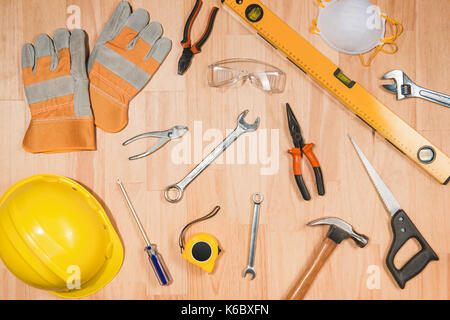 Construction safety helmet and tools supplies on wooden desk Stock Photo
