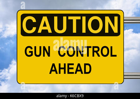 Gun control ahead, yellow road warning sign Stock Photo