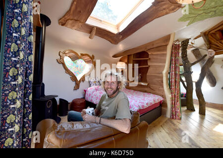 Ditchling Sussex, UK. 12th Sep, 2017. A new tree house has been unveiled at Blackberry Wood campsite near Ditchling in Sussex . The new upmarket tree house called Piggledy has been built by campsite owner Tim Johnson (pictured) and is larger than the original next door tree house called Higgledy . The quirky campsite is well known for having a London bus and an old Wessex helicopter where people can also stay in peaceful surroundings nestled just north of the South Downs National Park Credit: Simon Dack/Alamy Live News