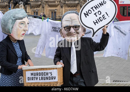 London, UK. 12th Sep, 2017. Masked protesters wait outside Parliament for the announcement of the referral to the Competition authorities of the 21st Century Fox bid for Sky Credit: Ian Davidson/Alamy Live News Stock Photo