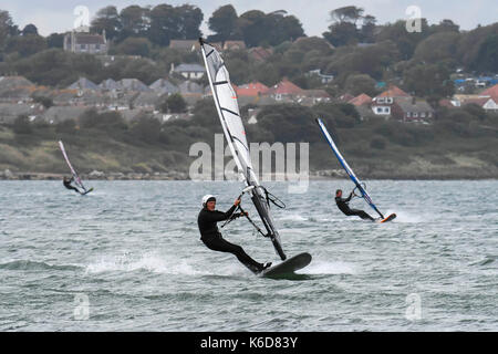 Portland, Dorset, UK. 12th Sep, 2017. UK Weather. Windsurfers take advantage of the strong winds to speed across the water in breakwater on the Isle of Portland in Dorset as strong winds build ahead of a stormy night with predicted gusts over 50mph. Photo Credit: Graham Hunt/Alamy Live News Stock Photo