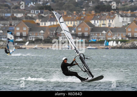 Portland, Dorset, UK. 12th Sep, 2017. UK Weather. Windsurfers take advantage of the strong winds to speed across the water in breakwater on the Isle of Portland in Dorset as strong winds build ahead of a stormy night with predicted gusts over 50mph. Photo Credit: Graham Hunt/Alamy Live News Stock Photo