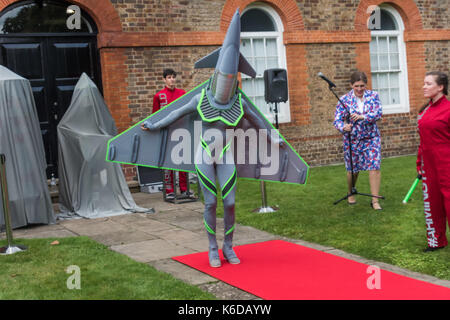 London, UK. 12th Sep, 2017. Samantha Lawson as the Eurofighter Typhoon in #ArmingTheWorld, a project by Ice & Fire theatre and Teatro Vivo with designer Takis at the first performance of their satirical weapons catwalk show spreading information about Defence and Security Equipment International (DSEI) to the general public in London at Woolwich Arsenal with actors dressed as arms dealers, a Paveway IV Missile, a Eurofighter Typhoon and CS Gas. Credit: Peter Marshall/Alamy Live News Stock Photo