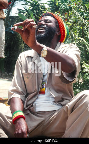 Rastafarian tour guide at Nine Mile, telling the group about Bob Marley. Jamaica Stock Photo