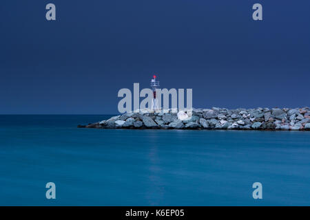Small red lighthouse in Platamonas Greece. Long exposure shot by night. Stock Photo