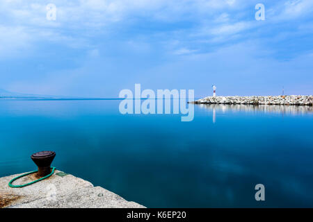 Small red lighthouse in Platamonas Greece. Long exposure shot by day Stock Photo