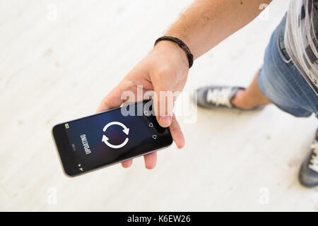 closeup of male hand using smartphone to update smartphone Stock Photo