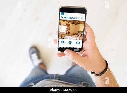 close up of male hand using booking hotel app smart phone Stock Photo