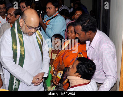 Kolkata, India. 12th Aug, 2017. Bharatiya Janta Party National President Amit Shah (left) interacts with the party members and their families who have been affected by the alleged political violence in state on September 12, 2017 in Kolkata. Credit: Saikat Paul/Pacific Press/Alamy Live News Stock Photo