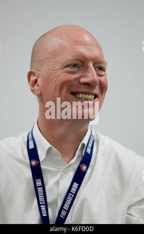 Matt Wrack, General Secretary of the Fire Brigades Union, speaks at a fringe meeting during the TUC conference at the Brighton Centre in Brighton. Stock Photo