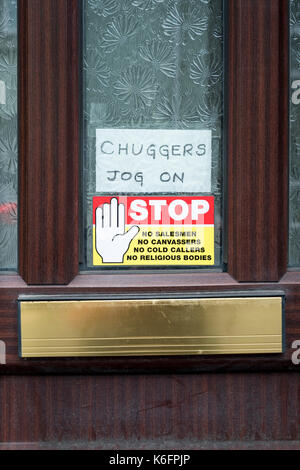 No salesmen, canvassers etc. etc. Chuggers jog on, sign on door of house Stock Photo