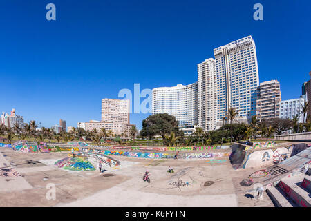 Beach Skateboard Park Durban, South-Africa - 20 Aug 2017: Durban beach front promenade skateboard park ocean  cycling people lifestyle landscape. Stock Photo