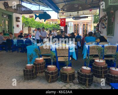 CUNDA ISLAND, TURKEY - MAY 21, 2017: An open air cafe of touristic town Cunda Alibey Island, Ayvalik. It is a small island in the northwestern Aegean Stock Photo