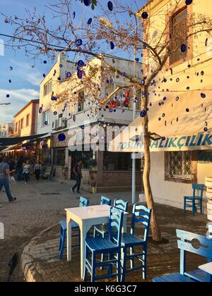 CUNDA ISLAND, TURKEY - MAY 21, 2017: An open air cafe of touristic town Cunda Alibey Island, Ayvalik. It is a small island in the northwestern Aegean Stock Photo