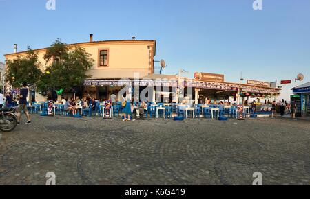 CUNDA ISLAND, TURKEY - MAY 21, 2017: An open air cafe of touristic town Cunda Alibey Island, Ayvalik. It is a small island in the northwestern Aegean Stock Photo