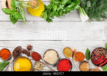 Various spices and herbs on wooden table. Top view with space for your text Stock Photo