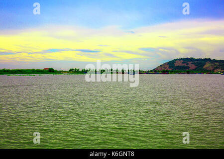 Cloudy Blue Sky and a Mountain Viewed from a Lakeside. Stock Photo