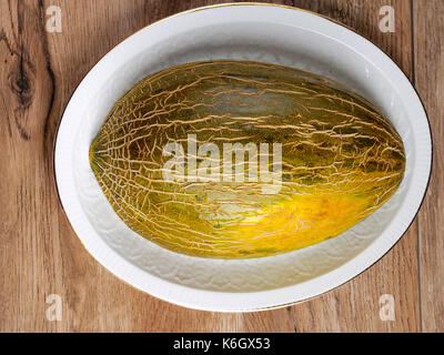 Green melon on wood background Stock Photo
