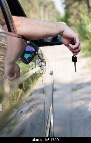 man's hand holds the keys to the car. Stock Photo