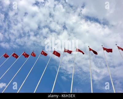 Many Turkish flags waving on the flagpoles Many Turkish flags waving on the flagpoles Stock Photo