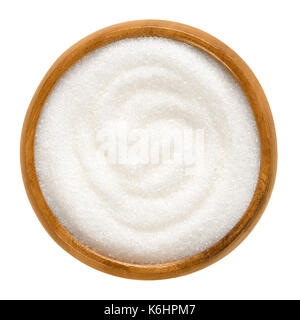 Fine granulated white sugar in wooden bowl. Crystals of refined table sugar. Sweet soluble carbohydrates. Sucrose. Macro photo. Stock Photo