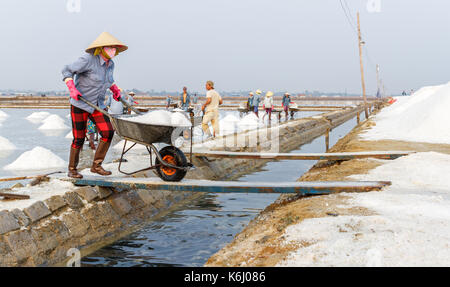 NHA TRANG, VIETNAM - 4/12/2016: A woman works at the Hon Khoi salt fields in Nha Trang, Vietnam. Stock Photo