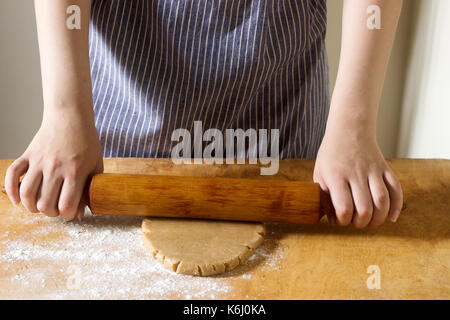 Woman rolling dough for gingerbread, rustic style, selective focus Stock Photo