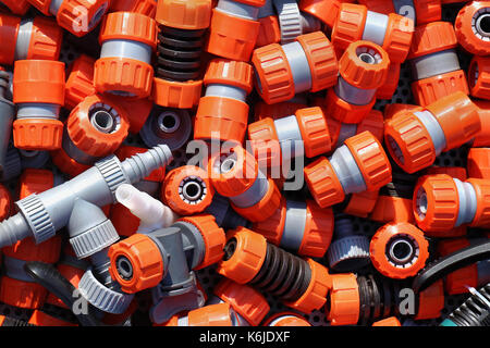 Large pile of plastic garden hose fittings Stock Photo