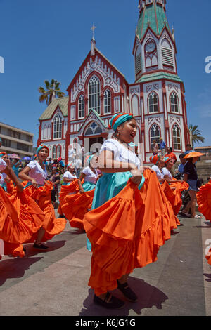Female dancers from the group Tumba Carnaval, performing at the annual street carnival celebrating the strength of the sun in Arica, Chile. Stock Photo