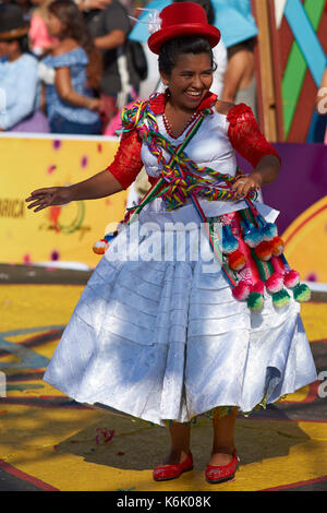 Pueblo dance group in ornate costume performing at the annual Carnaval Andino con la Fuerza del Sol in Arica, Chile. Stock Photo