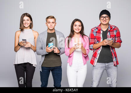 Fours Friends using gadget technology Phone isolated on grey Stock Photo
